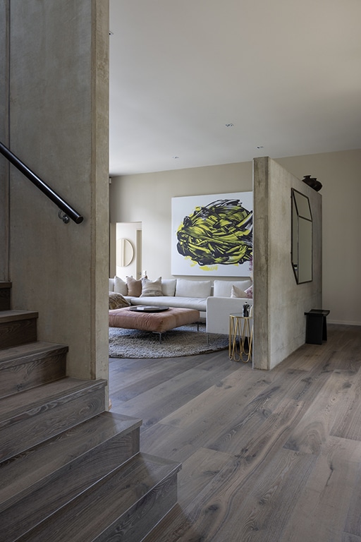 Timber stair treads set between raw concrete columns