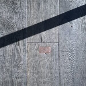 European made timber floor heavy textured with repair patches dark oak