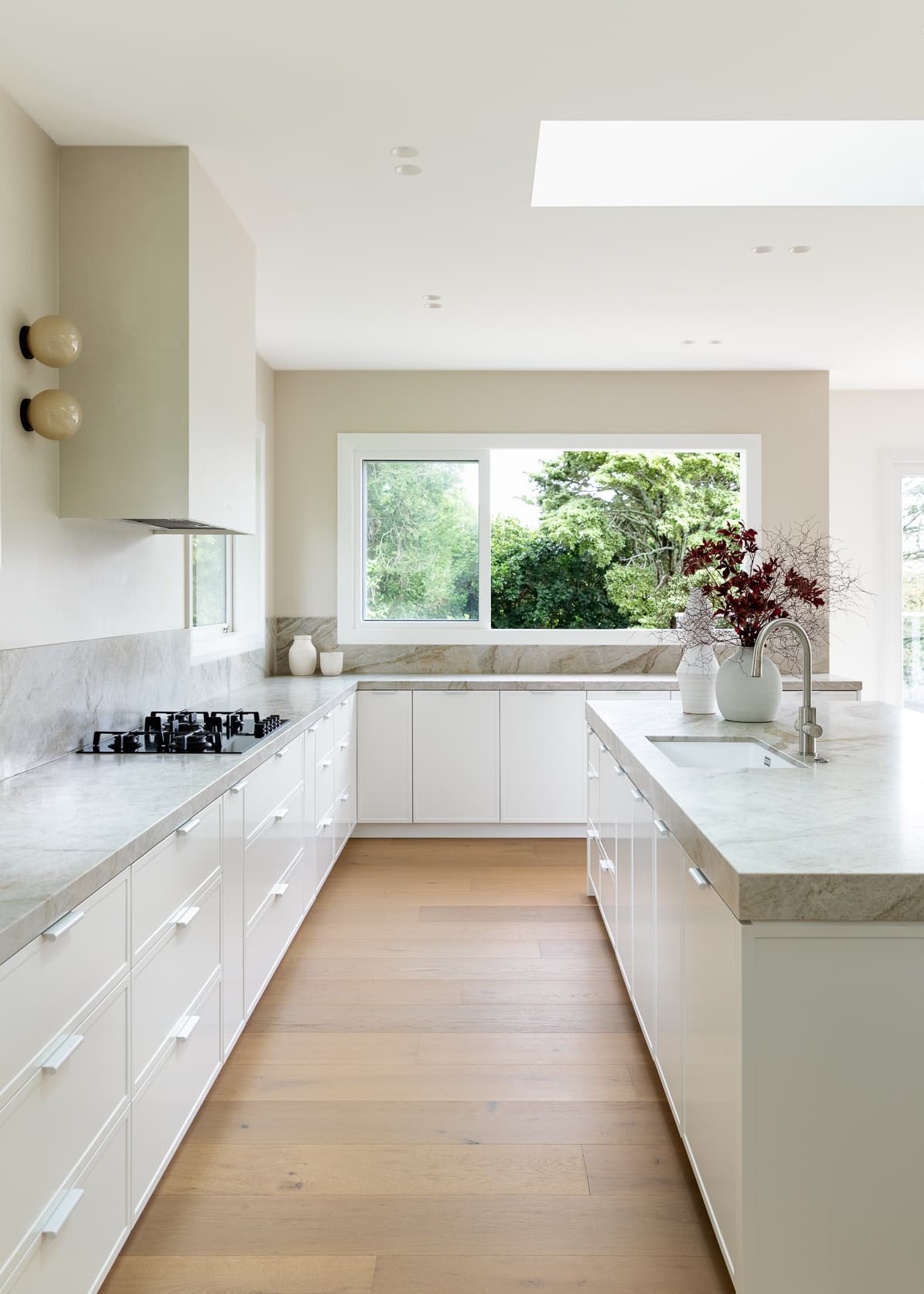 Galley kitchen with wide oak boards running through