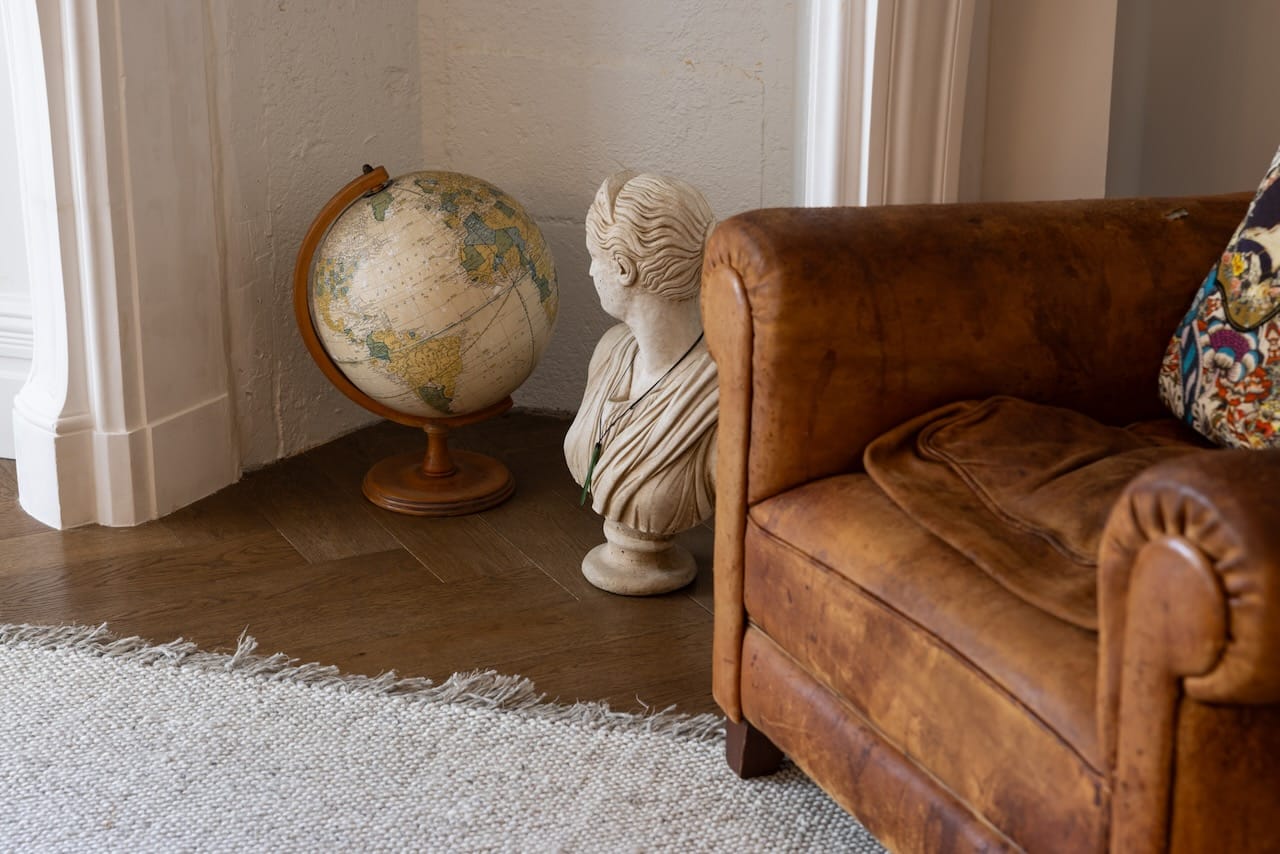 Herringbone Flooring with old style leather armchair