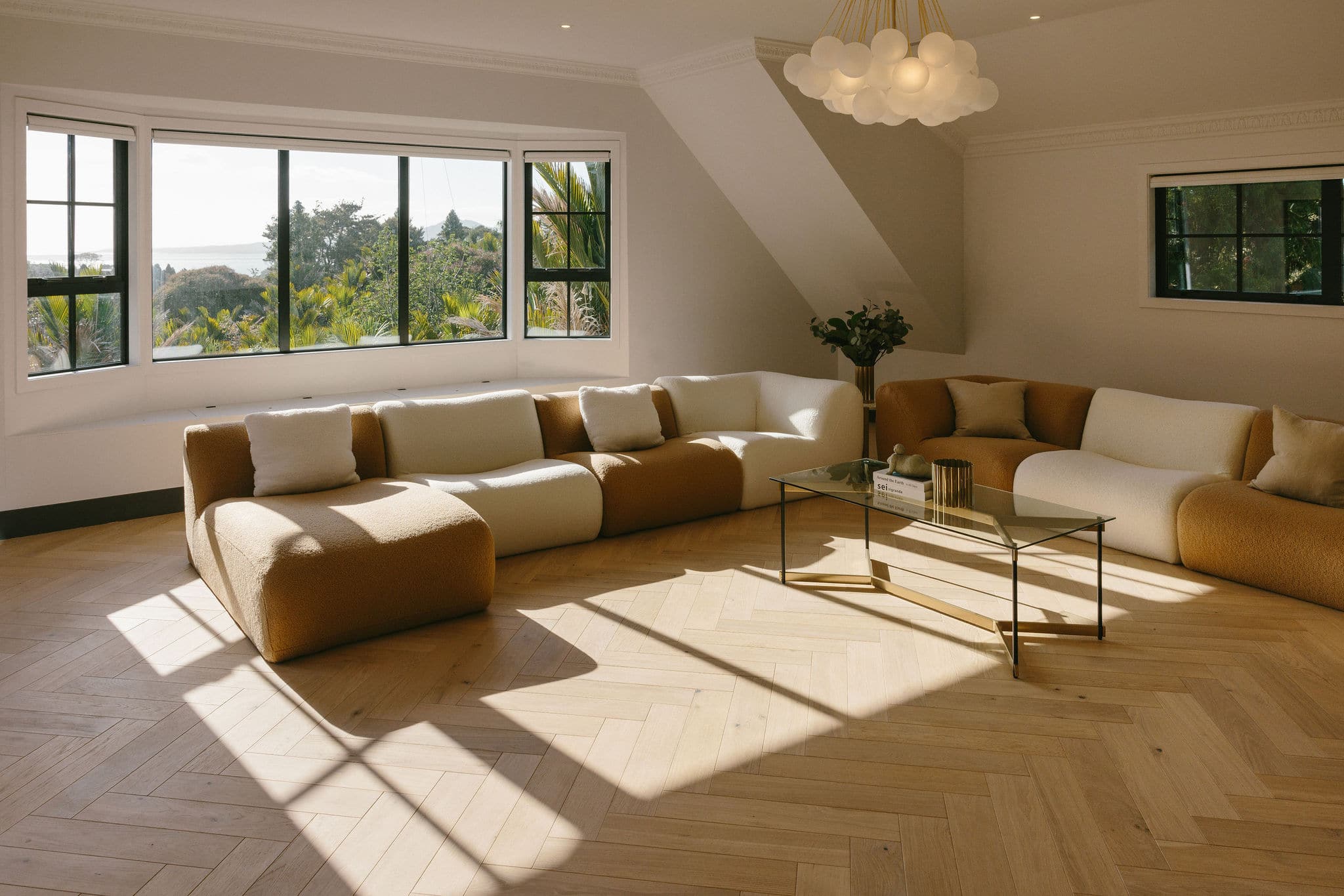 Living room with herringbone European oak flooring and an ocean outlook in Saint Heliers