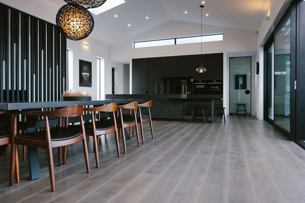 Dark rich Oak flooring long lengths in open lounge dining and kitchen