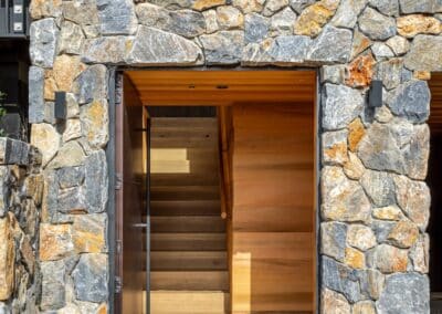 Hallway view of the Waiheke Island project highlighting Manhattan oak timber flooring and wood accents from Vienna Woods Distilled Collection.