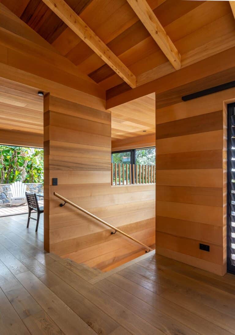 Entrance area of the Waiheke Island project showcasing Manhattan oak timber flooring and modern wood paneling.