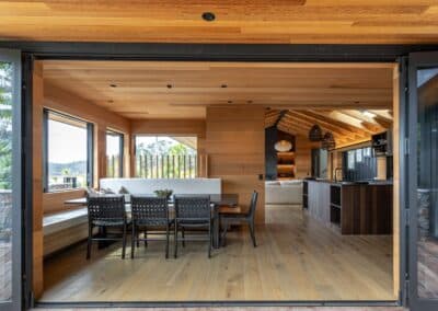 Bright kitchen and dining area of the Waiheke Island project featuring Manhattan oak timber flooring and contemporary furnishings.