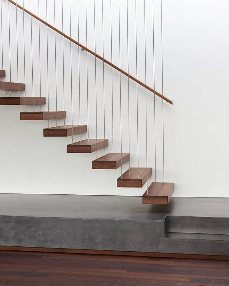 Engineered European oak timber stairs with open risers and cable balustrade in New Zealand home