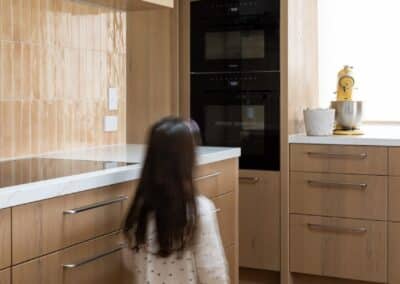 Bordeaux European oak timber flooring in Auckland kitchen with warm timber joinery