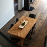 Wide plank European oak flooring surrounding a timber dining table viewed from above in a Queenstown New Zealand home
