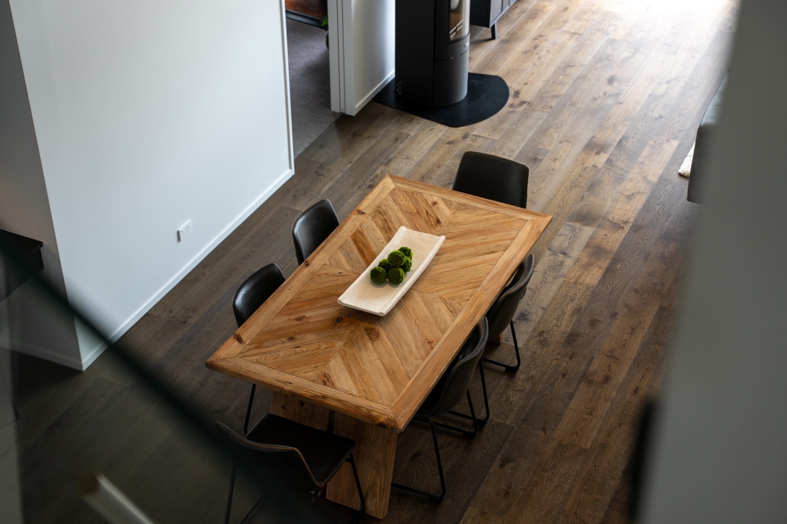 Wide plank European oak flooring surrounding a timber dining table viewed from above in a Queenstown New Zealand home