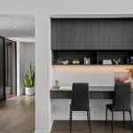 Wide plank European oak flooring in a modern built-in home office niche with floating desk, shelving and two chairs in a Queenstown New Zealand home
