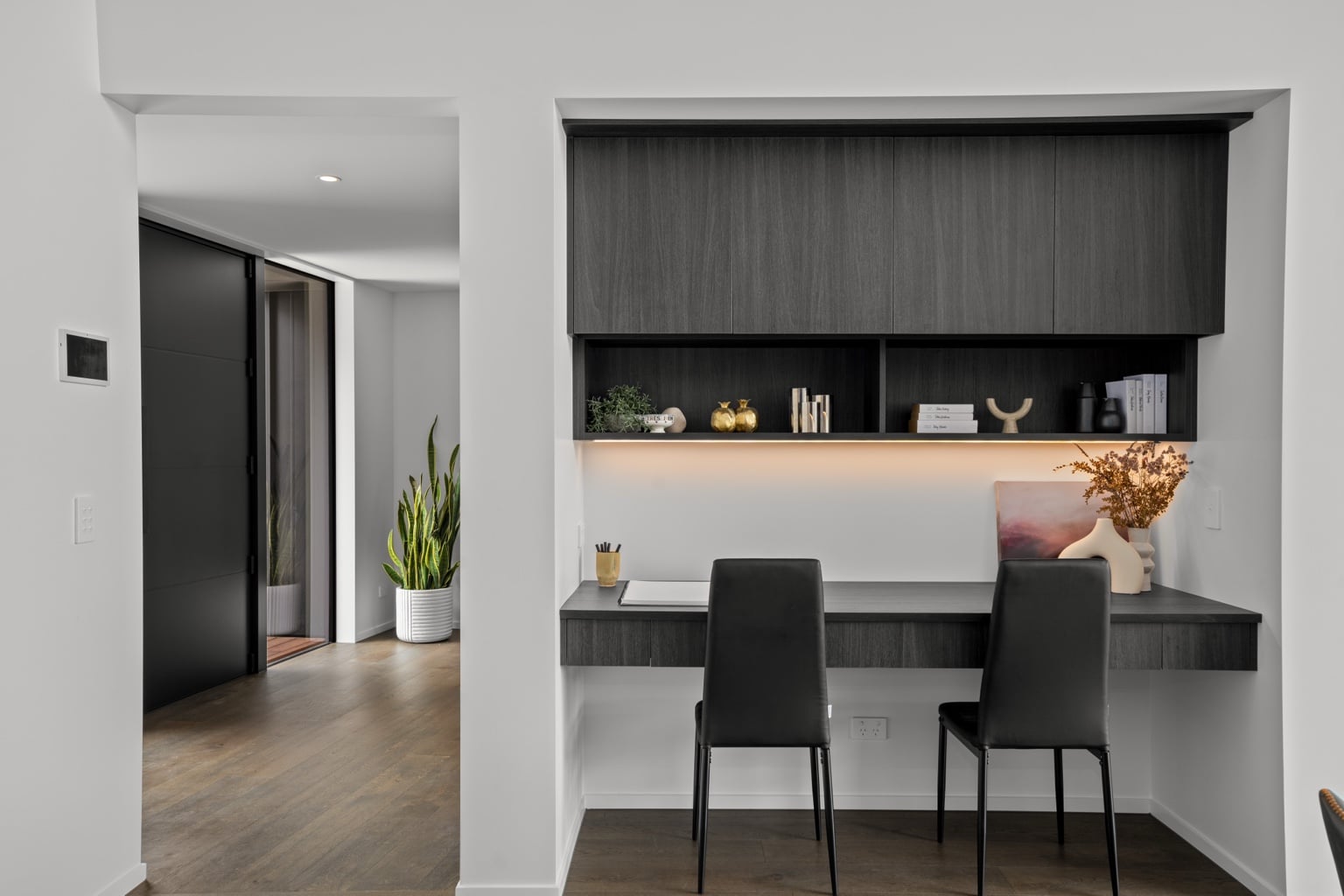 Wide plank European oak flooring in a modern built-in home office niche with floating desk, shelving and two chairs in a Queenstown New Zealand home