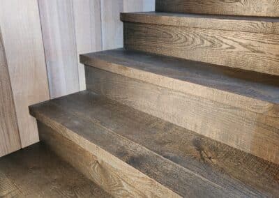 Close up of engineered oak timber stair treads showing grain detail and dark finish
