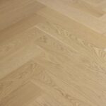 Close-up of Bordeaux engineered oak herringbone flooring in a Westmere home