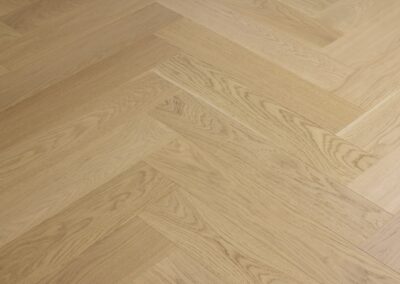 Close-up of Bordeaux engineered oak herringbone flooring in a Westmere home
