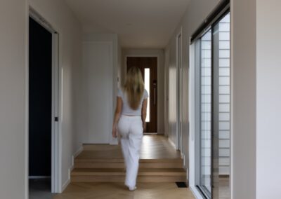 Lifestyle view of entry hallway with Bordeaux herringbone oak flooring in Westmere home