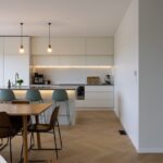 Open plan kitchen and living area with Bordeaux herringbone oak flooring in Westmere home