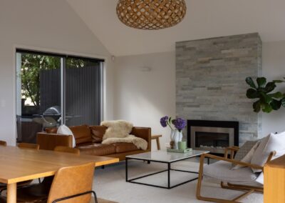 Open plan living with vaulted ceiling over Bordeaux herringbone oak flooring in Westmere home