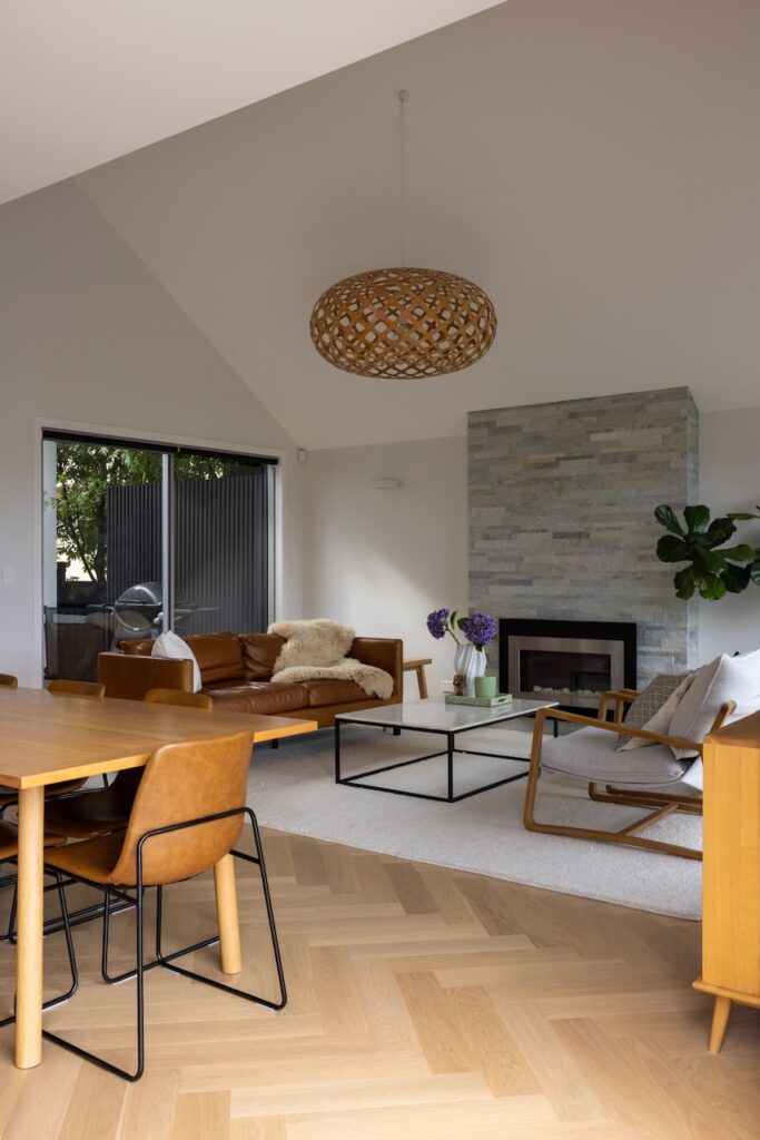 Open plan living with vaulted ceiling over Bordeaux herringbone oak flooring in Westmere home