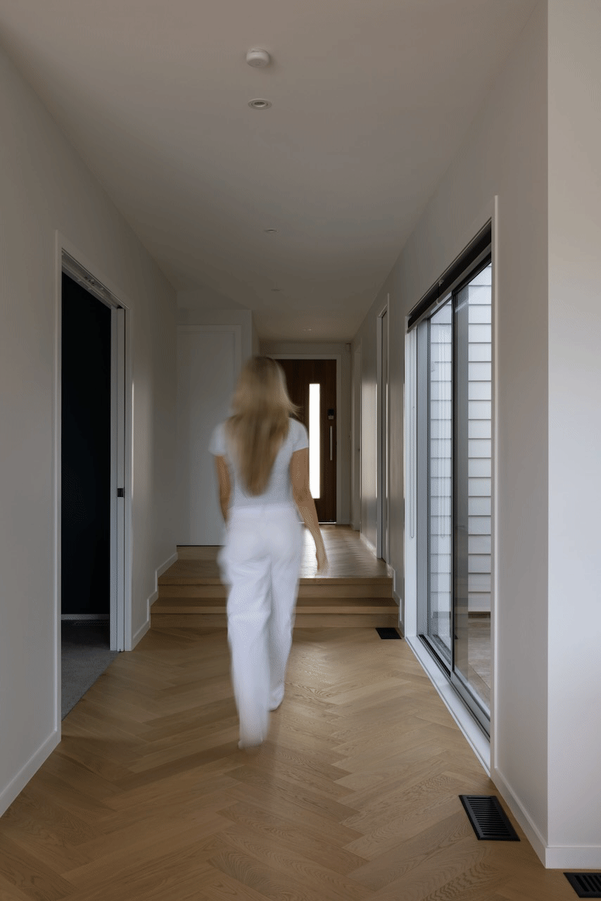 Bordeaux oak herringbone flooring running through hallway in Westmere home