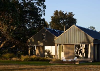Modern coastal architectural home exterior with timber cladding and gable roof design in Coromandel