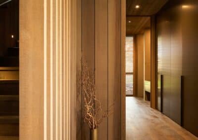 Engineered oak timber flooring in modern corridor with timber ceiling lining and natural light from window