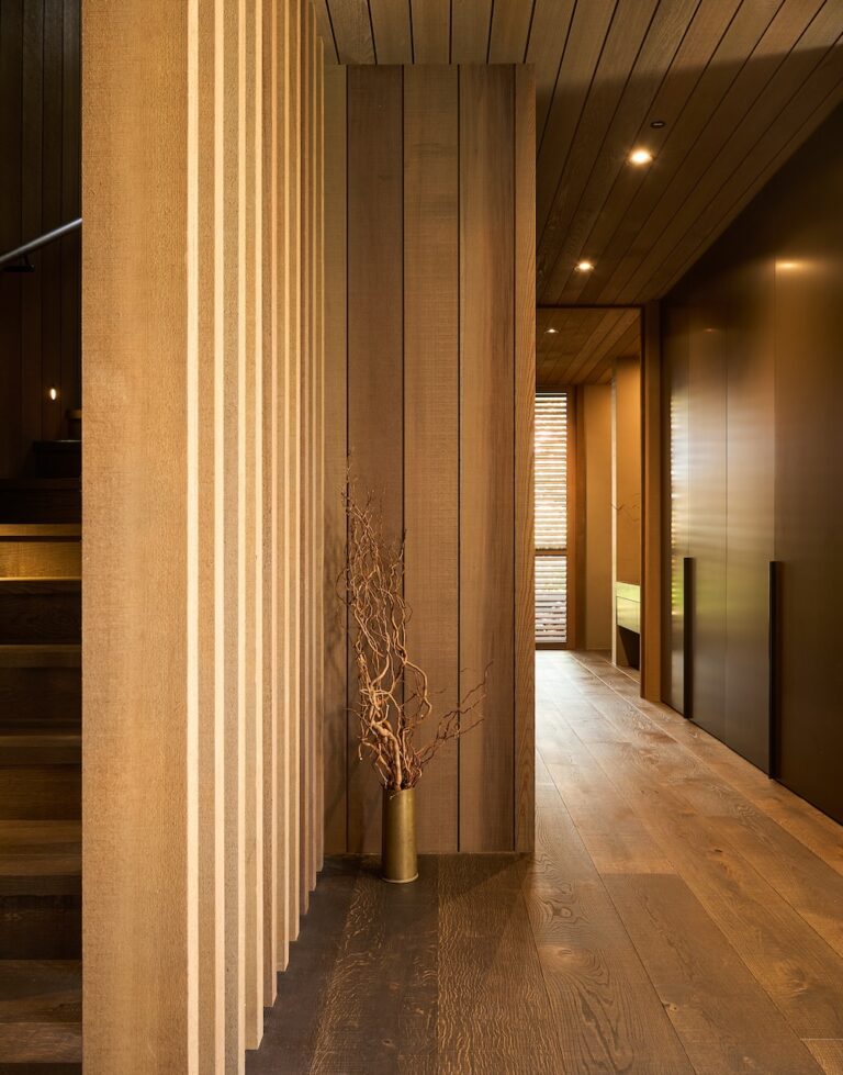 Engineered oak timber flooring in modern corridor with timber ceiling lining and natural light from window