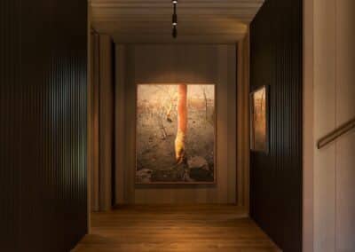 Dark engineered oak timber flooring in architectural hallway with timber ceiling lining and vertical wall battens