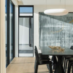 Westwood engineered oak flooring beneath a pendant-lit dining table, Westmere Auckland.