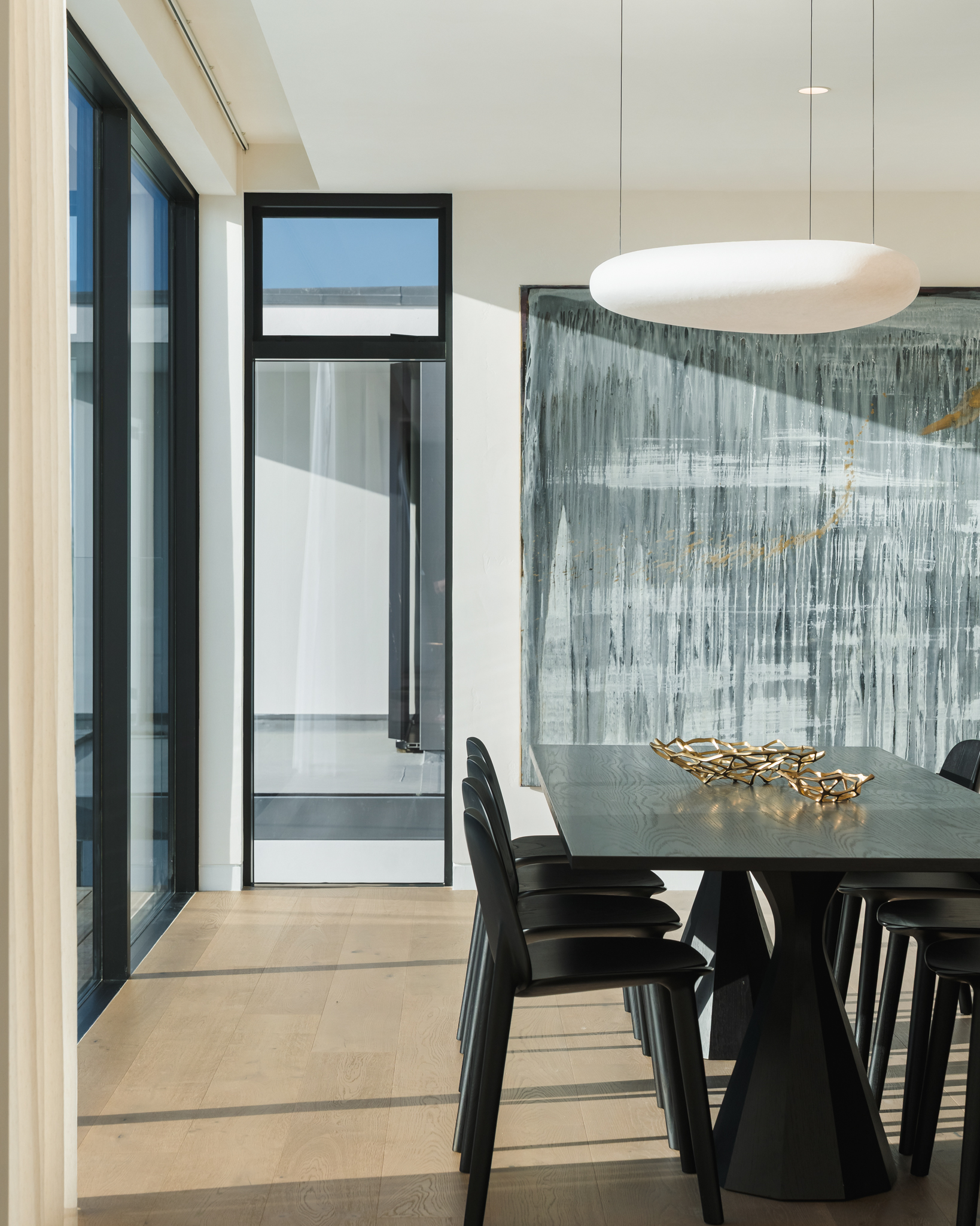 Westwood engineered oak flooring beneath a pendant-lit dining table, Westmere Auckland.
