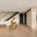 Westwood engineered oak flooring continuing under a floating staircase, Westmere Auckland home.