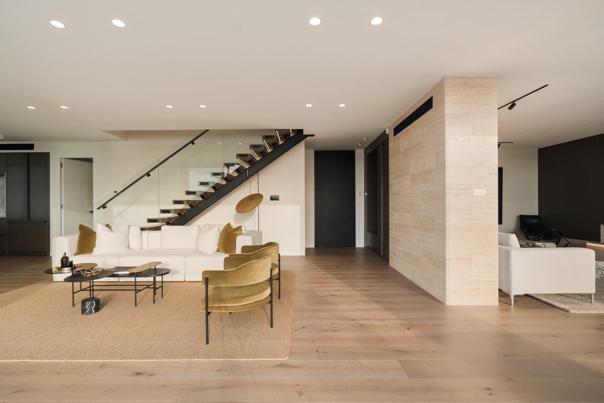 Westwood engineered oak flooring continuing under a floating staircase, Westmere Auckland home.