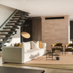 Westwood engineered European oak flooring in lounge framed by floating timber stairs, Westmere Auckland.