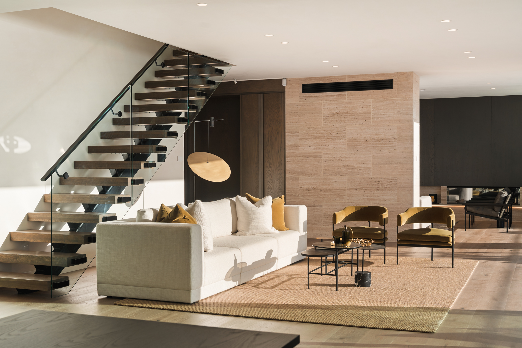 Westwood engineered European oak flooring in lounge framed by floating timber stairs, Westmere Auckland.