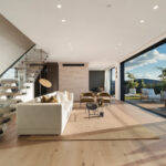 Westwood engineered oak flooring in living room with floating stairs and harbour view, Westmere.
