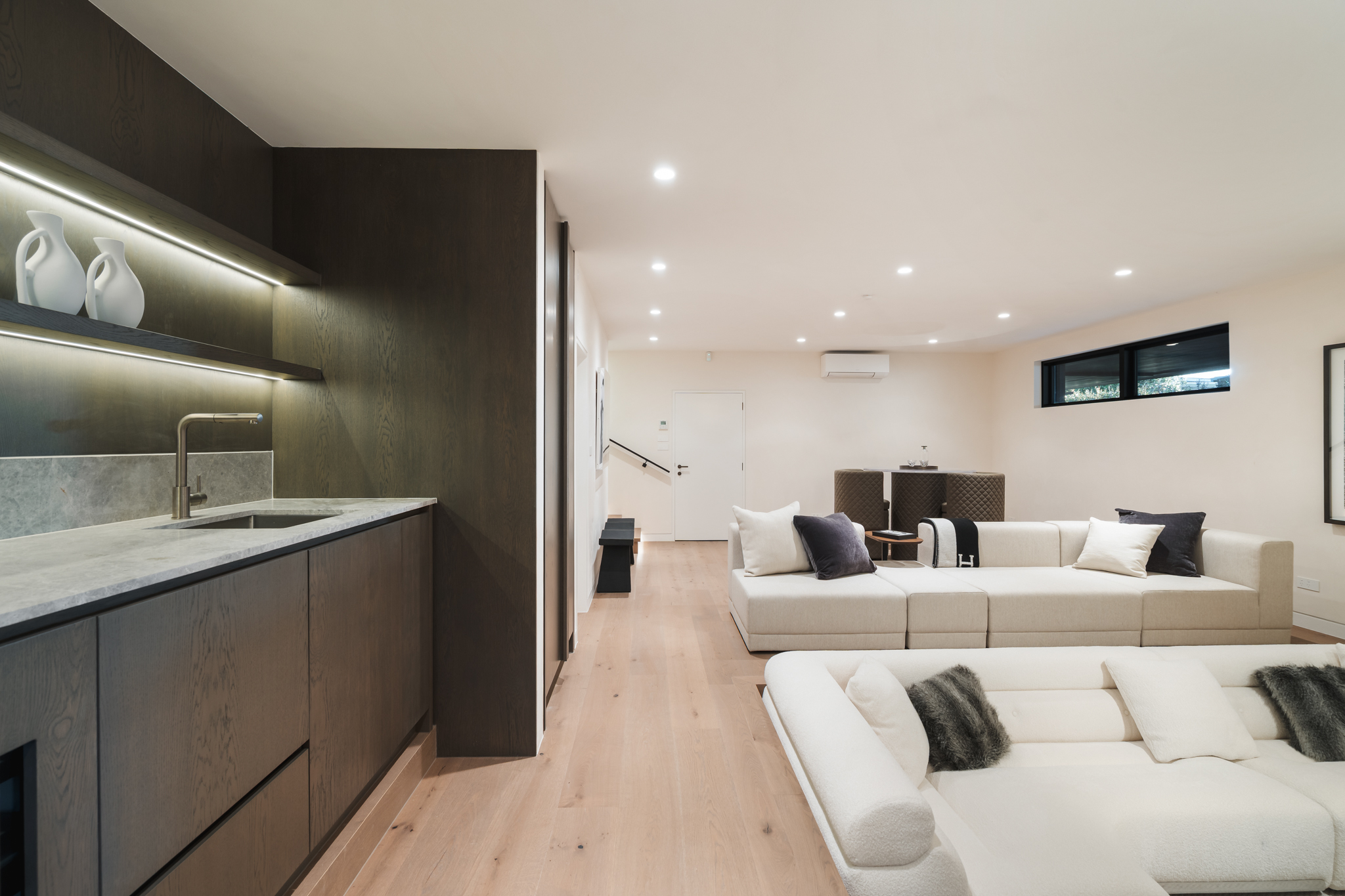 Westwood engineered oak flooring in lower lounge with kitchenette, Westmere Auckland.