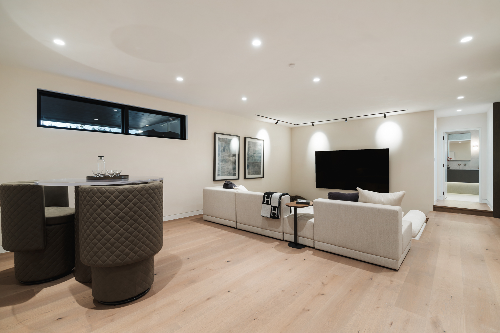 Westwood engineered oak flooring in lower-level media lounge, Westmere Auckland.