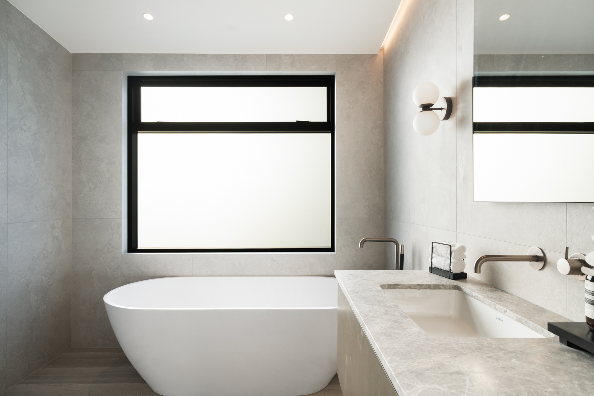 Westwood engineered oak flooring beside freestanding bathtub in master bathroom, Westmere Auckland.
