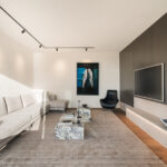 Westwood engineered oak flooring in a media room with feature wall, Westmere Auckland.