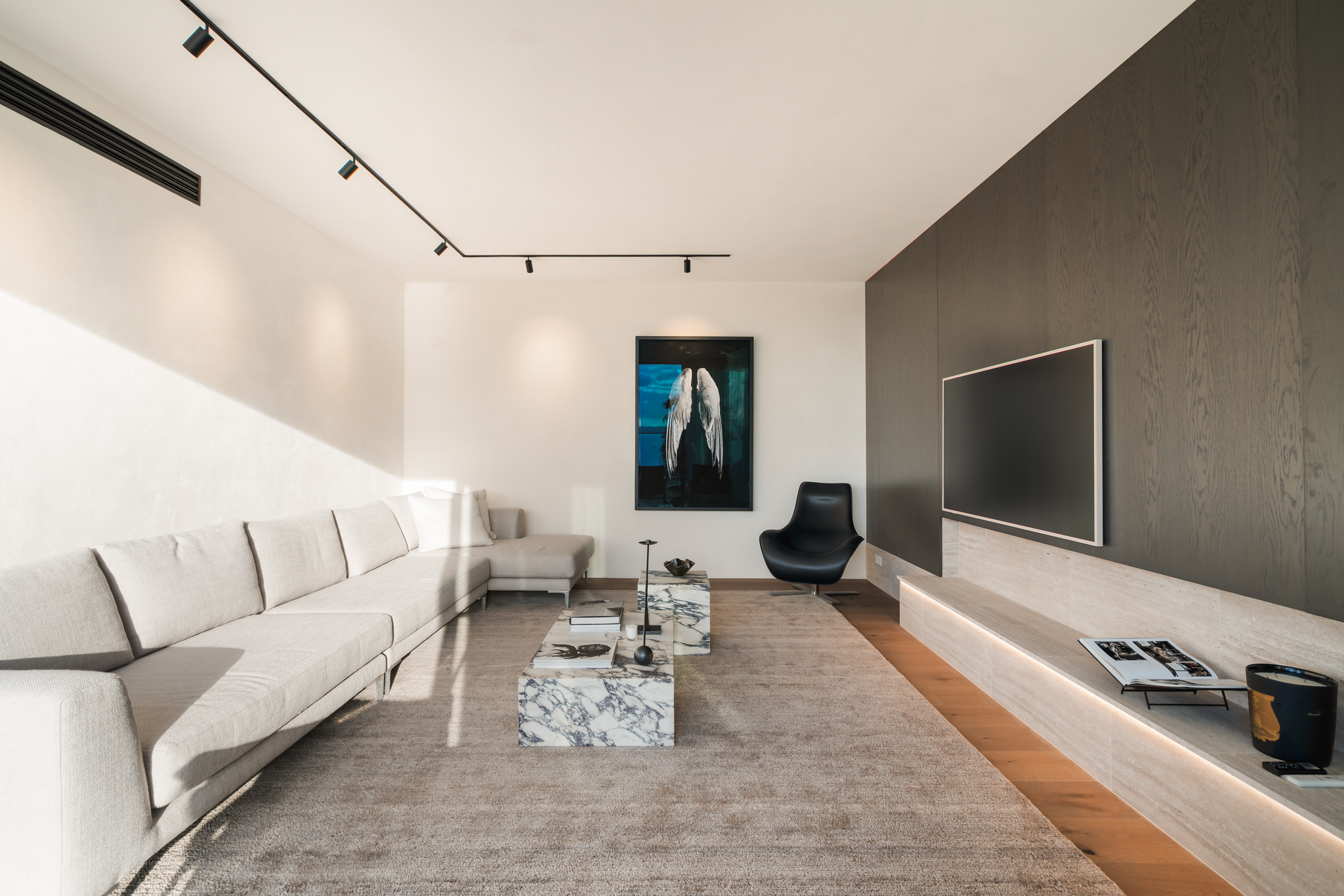 Westwood engineered oak flooring in a media room with feature wall, Westmere Auckland.