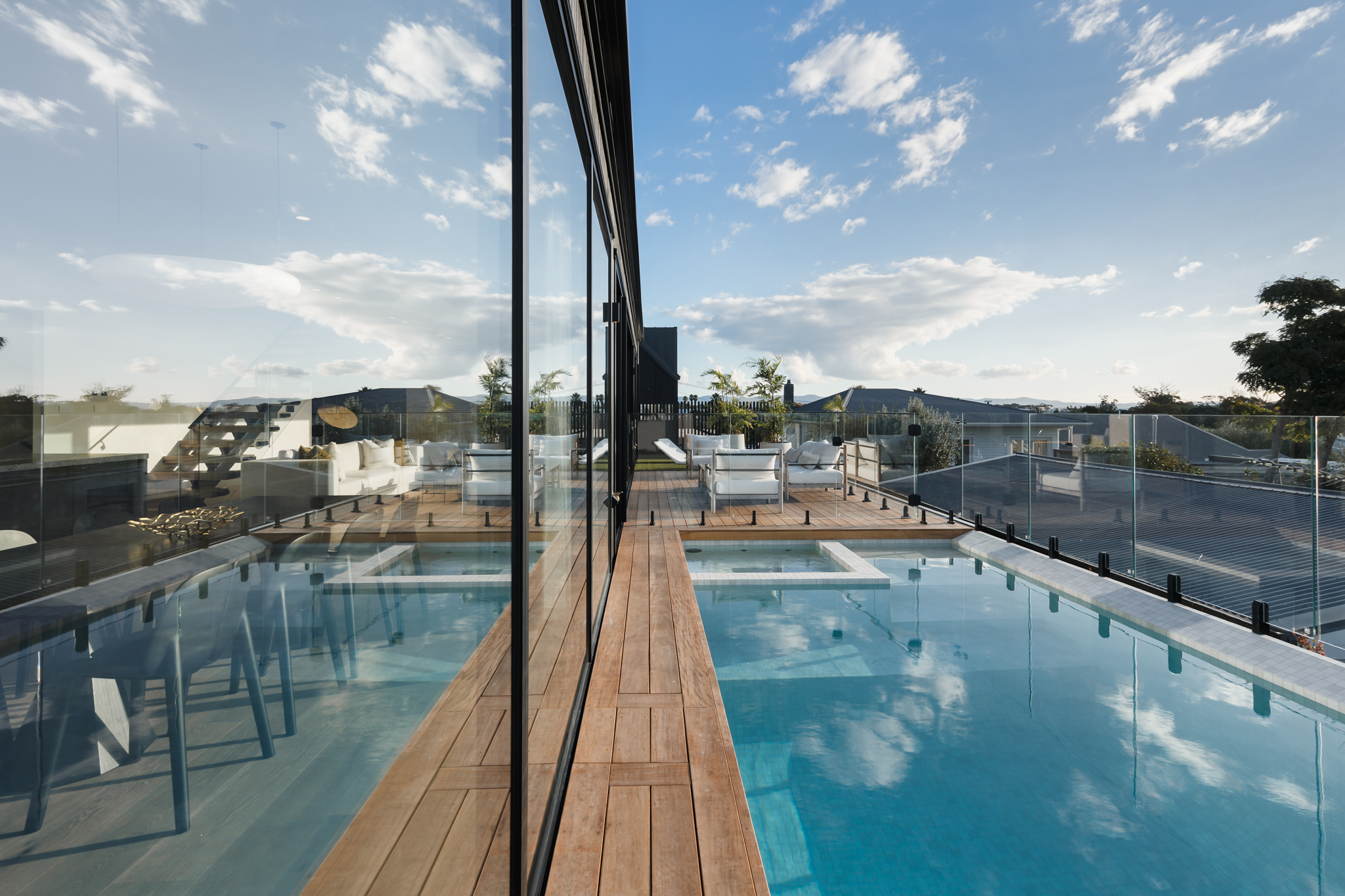 Infinity pool and deck with Auckland skyline view, Westmere residence.