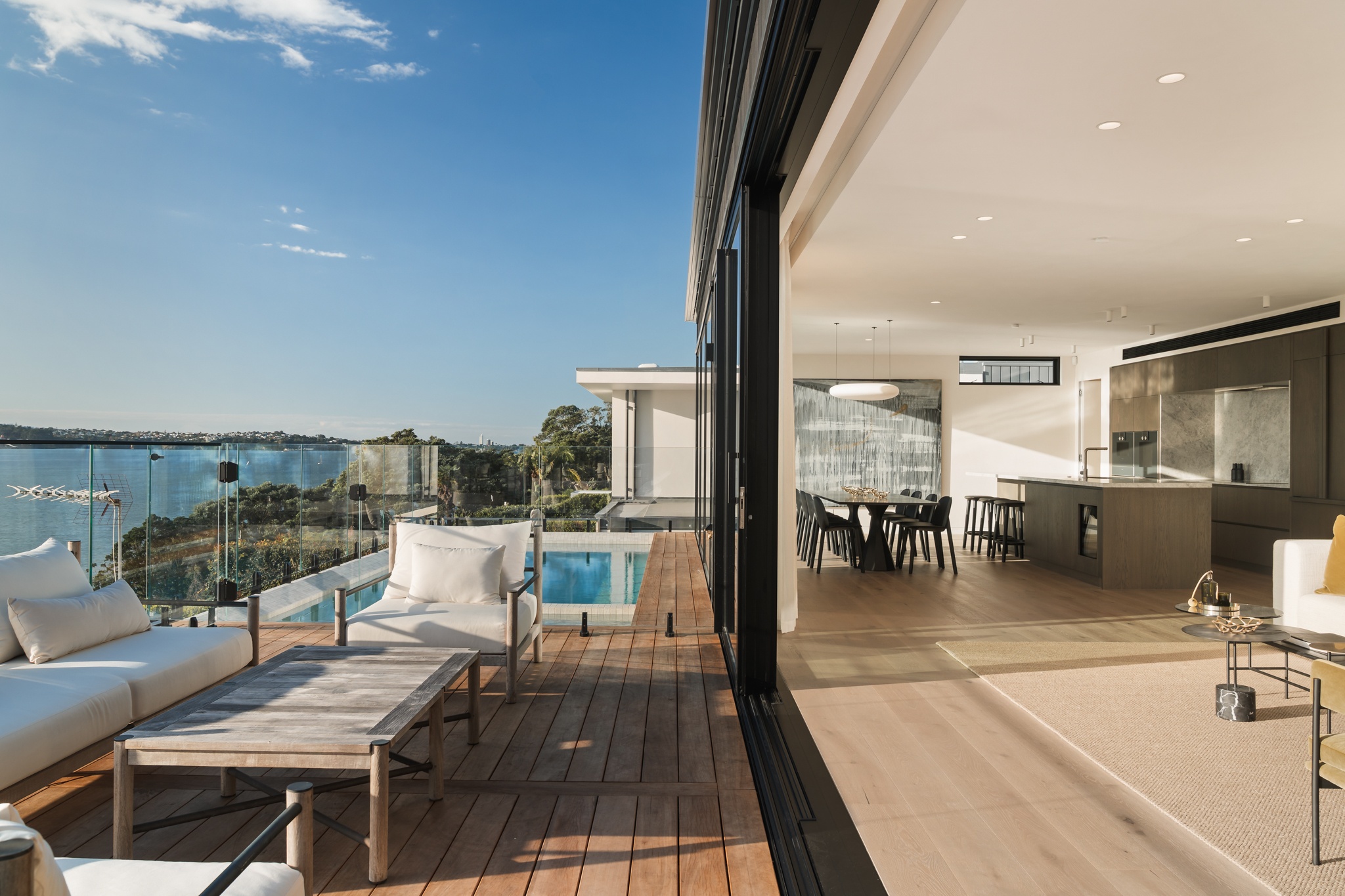 Infinity pool with Auckland harbour view at Westmere residence by MacFie Architecture.