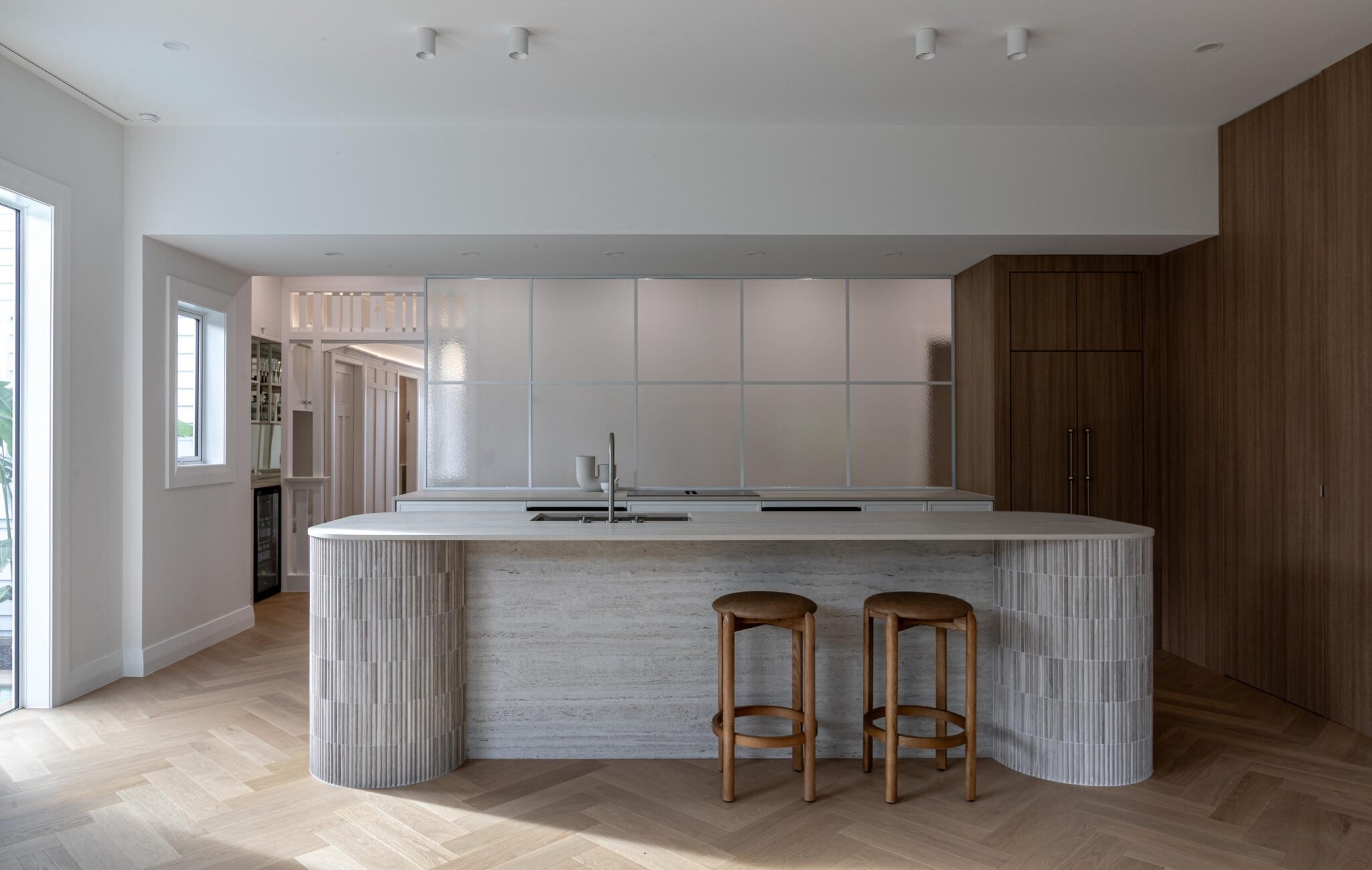 Bordeaux Herringbone oak parquet running through an open-plan Ponsonby kitchen, with the sink set into the island