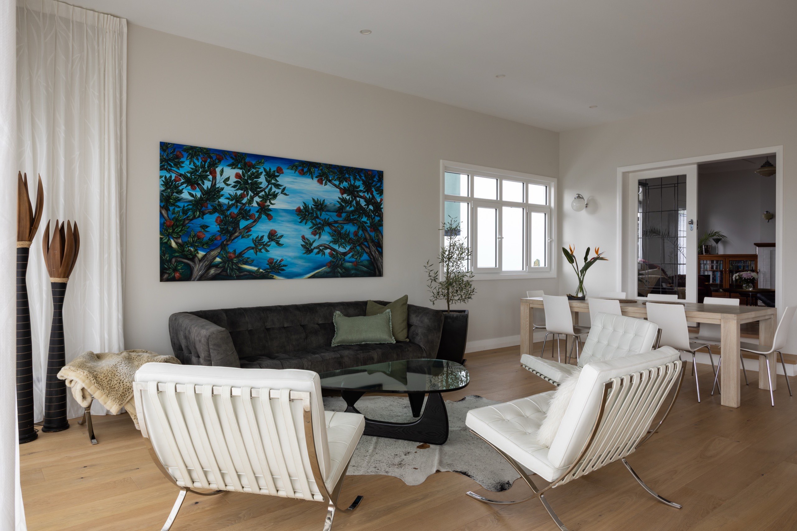 Open-plan living and dining area floored in Sazerac wide-plank oak in a Saint Heliers home by Vienna Woods.