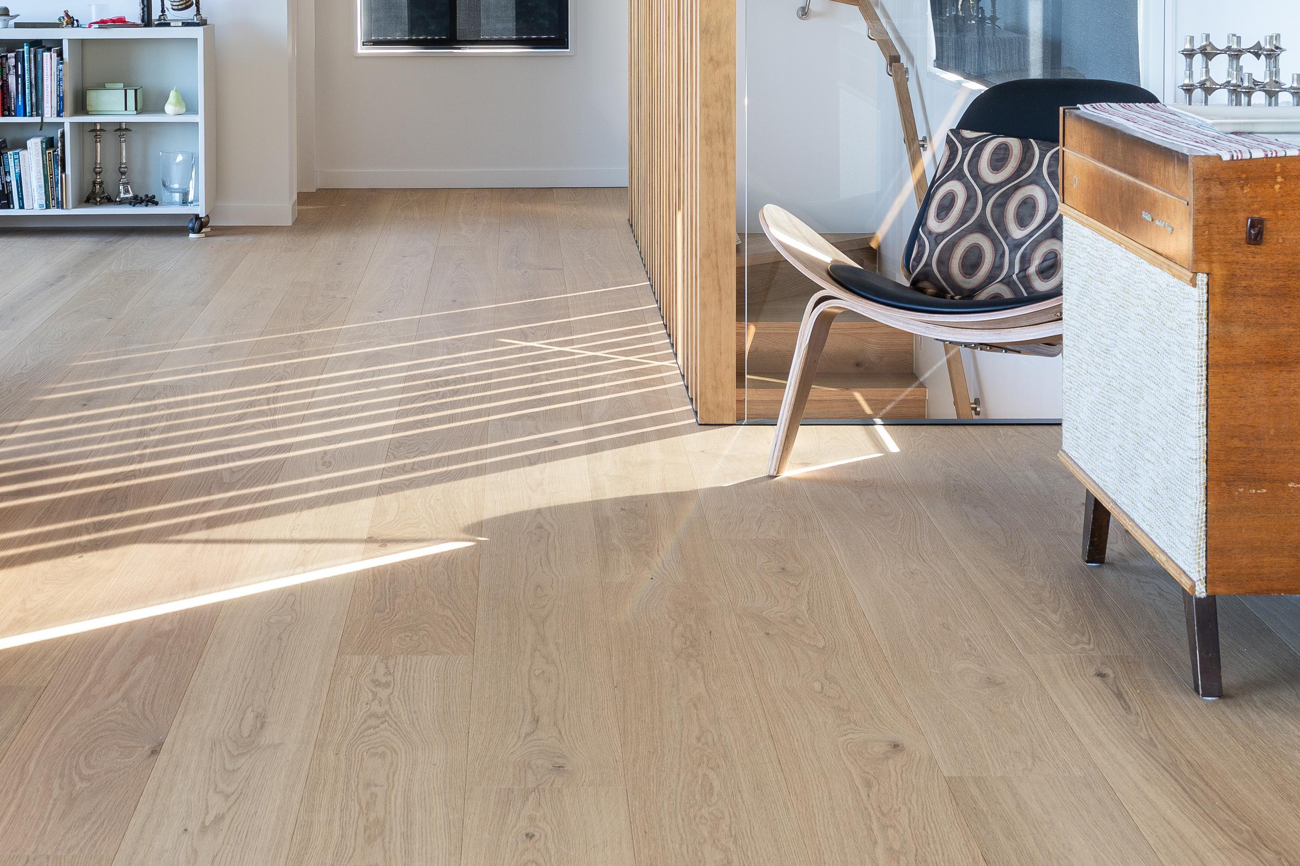 Close view of Foundation Pureline prime-grade oak flooring, low sun raking across the boards.