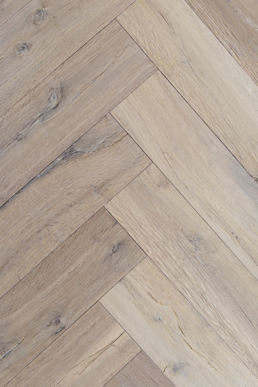 Rustic brushed oak herringbone parquet with filled knots and heavy texture